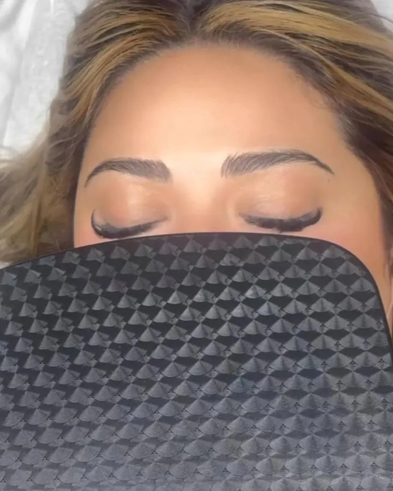 Client with freshly laminated, lifted brows, eyes closed
